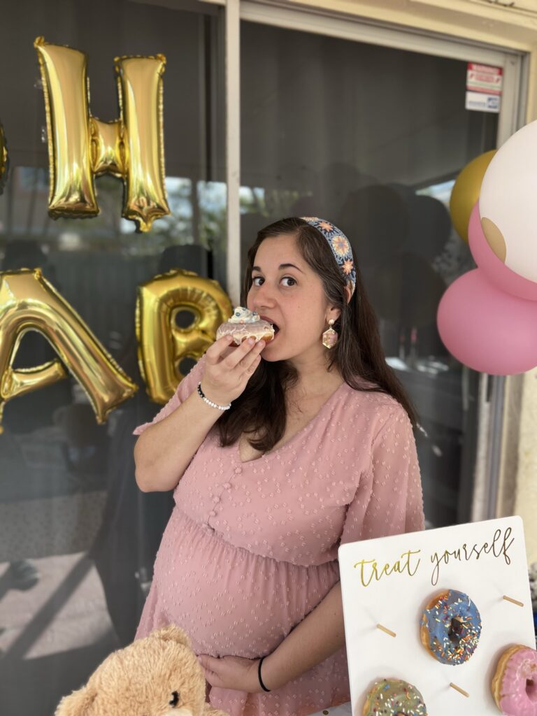 Photo of girl with donut at Gender Reveal Party