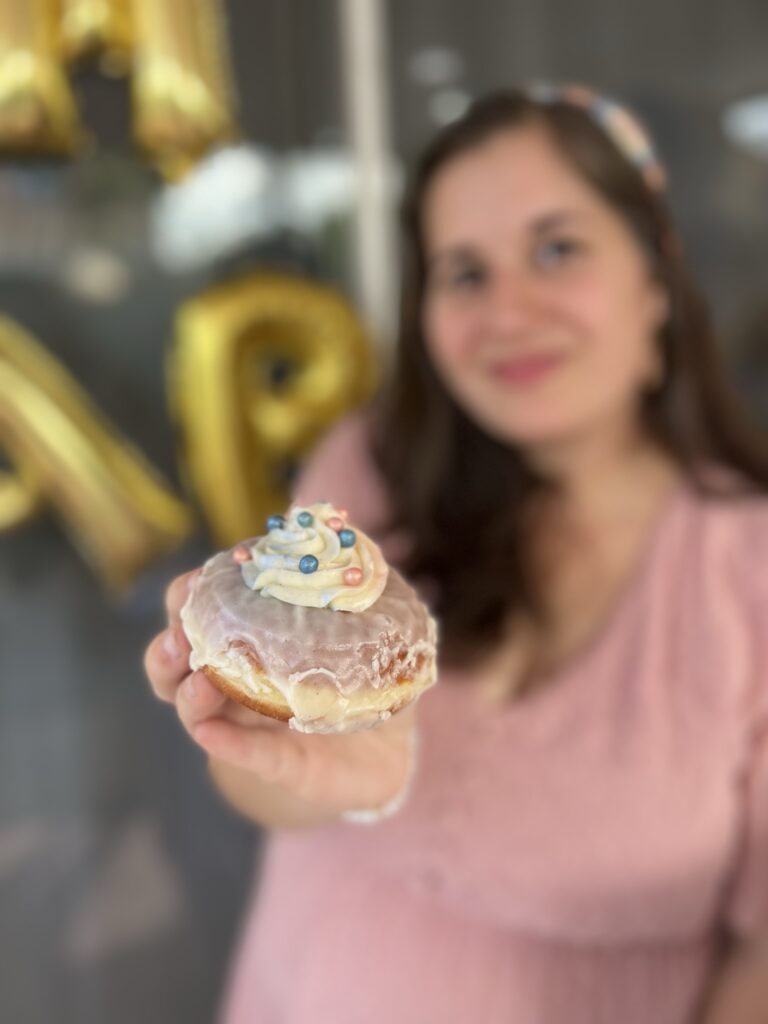 Photo of girl with donut at Gender Reveal Party