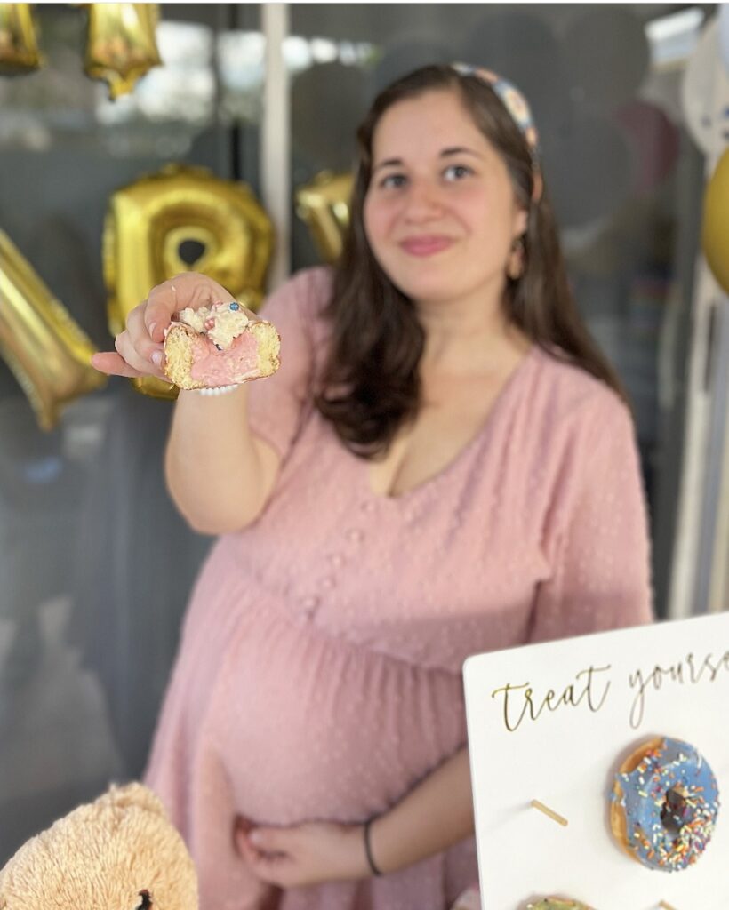 Photo of girl with donut at Gender Reveal Party