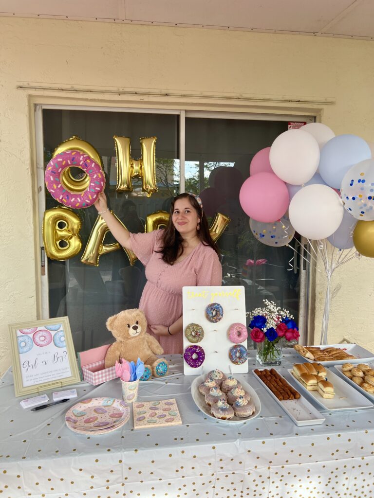 Photo of girl with donut at Gender Reveal Party