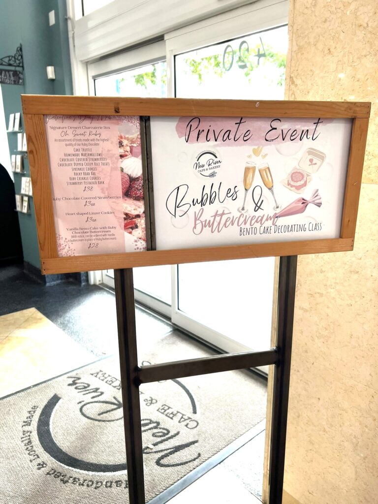 Photo of Bubbles and Buttercream Galentines Event Sign at New River Cafe and Bakery